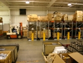 forklift accessing bulk storage on mobilized pallet racks in warehouse