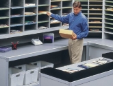 Man Sorting Mail into Mailroom Sorter Furniture