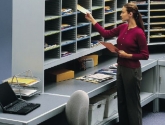 Woman Sorting Mail in Mail Room Sorter Furniture